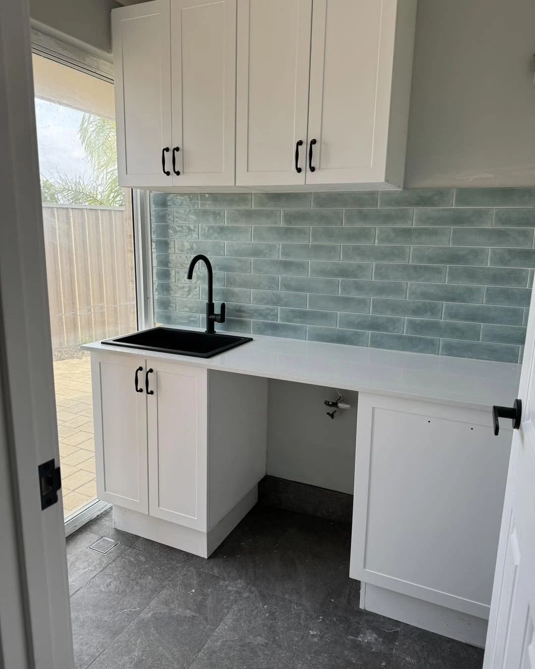 Laundry cabinetry with sink and appliance space